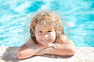 Happy little boy playing in swimming pool outdoor on hot summer day. Children fun. Enjoying in swimming pool.