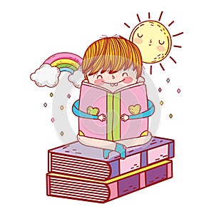Happy little boy reading books