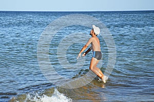 A happy little boy on the seashore