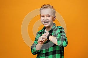 Happy little boy with a smartwatch.