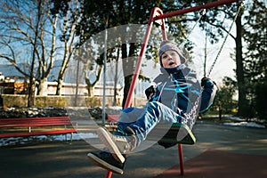 Happy little boy on swing