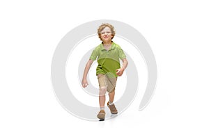 Happy little caucasian boy jumping and running isolated on white background