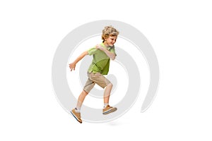 Happy little caucasian boy jumping and running isolated on white background