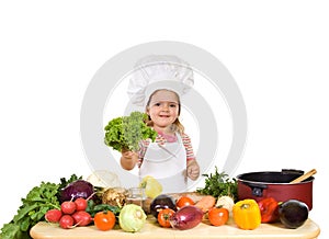 Happy little chef with lots of vegetables