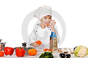 Happy little chef with lots of vegetables. isolated