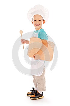 Happy little chef with wooden board and spoon