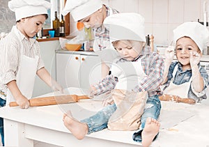 Happy little chefs preparing dough in the kitchen