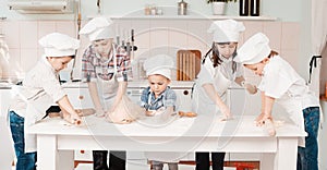 Happy little chefs preparing dough in the kitchen