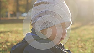 Happy little child, baby boy laughing and playing in the autumn in the park walk outdoors.