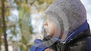 Happy little child, baby boy laughing and playing in the autumn in the park walk outdoors.