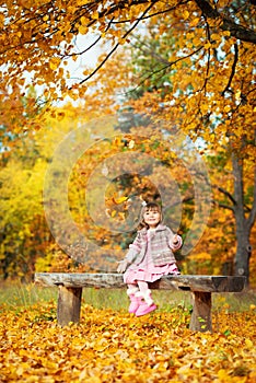 Happy little child, baby girl laughing and playing in the autumn on the nature walk outdoors