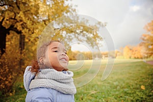 Happy little child, baby girl laughing and playing in the autumn on the nature walk outdoors