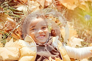 Happy little child, baby girl laughing and playing in the autumn on the nature walk outdoors