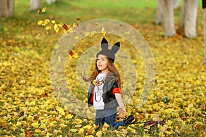 Happy little child, baby girl laughing and playing in the autumn on the nature walk outdoors.