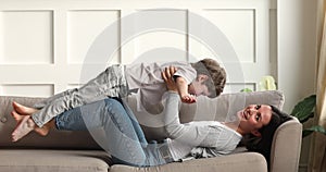 Happy little child boy playing airplane with older sister.