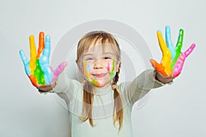 Happy little child girl art school student with her colorful painted hands on white. Girl drawing