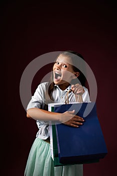 happy little child girl holds many shopping bags