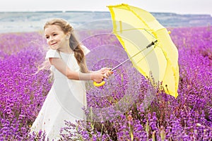 Happy little child girl in lavender field with