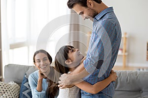 Happy little child hug dad excited parents reunited