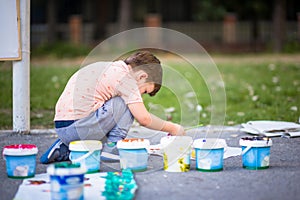 HAPPY LITTLE CHILD PAINTING ON CANVAS WITH WATER COLOURS