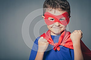 Happy little child playing superhero.