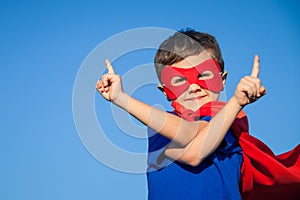 Happy little child playing superhero.