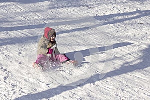 Happy little child sledging