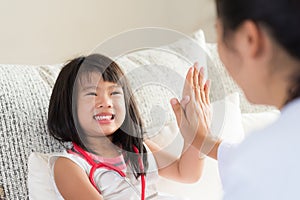 Happy little cute girl on consultation at the pediatrician. Girl