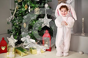 Happy little cute girl stands in bunny costume