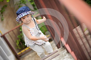 Happy little cute girl walking up the stairs.