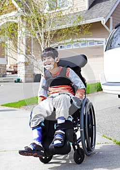 Happy little disabled boy in wheelchair