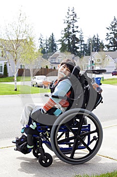 Happy little disabled boy in wheelchair