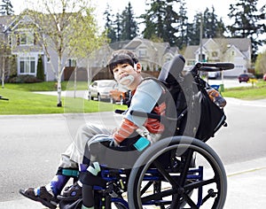 Happy little disabled boy in wheelchair photo