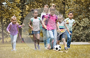 Happy little friends going to nature with school teacher.