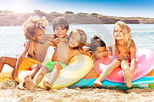 Happy little friends spending summer on the beach