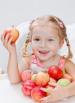 Happy little girl with apple