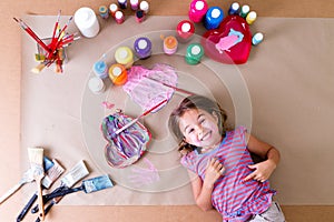 Happy little girl artist with her art supplies