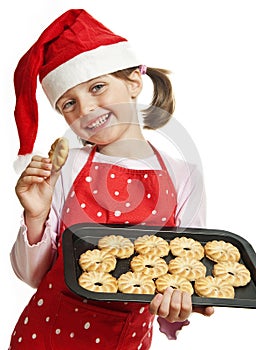 Happy little girl baking Christmas cookies