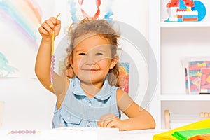 Happy little girl with beads on a string