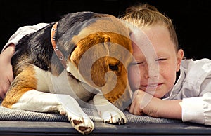 Happy little girl and beagle puppy