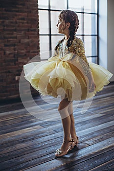 Happy little girl in a beautiful dress.