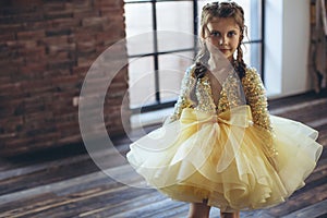 Happy little girl in a beautiful dress.