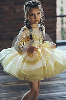 Happy little girl in a beautiful dress.