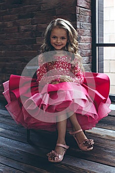 Happy little girl in a beautiful dress.