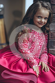 Happy little girl in a beautiful dress.