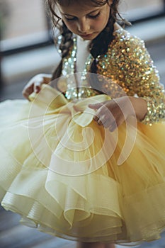 Happy little girl in a beautiful dress.