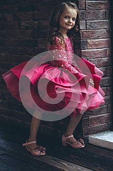 Happy little girl in a beautiful dress.