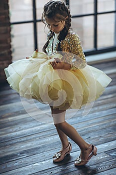 Happy little girl in a beautiful dress.