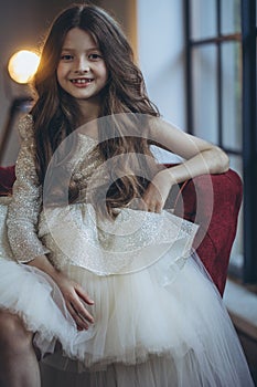 Happy little girl in a beautiful dress.