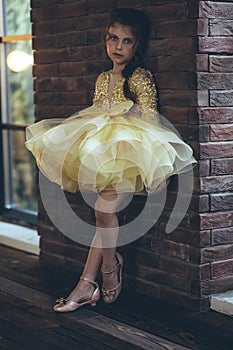 Happy little girl in a beautiful dress.